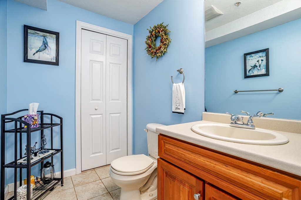 101 Bridle Cross Road, Unit 101 Fitchburg, MA 01420 - Photo 23 of 26 a bathroom with a sink a toilet and a mirror