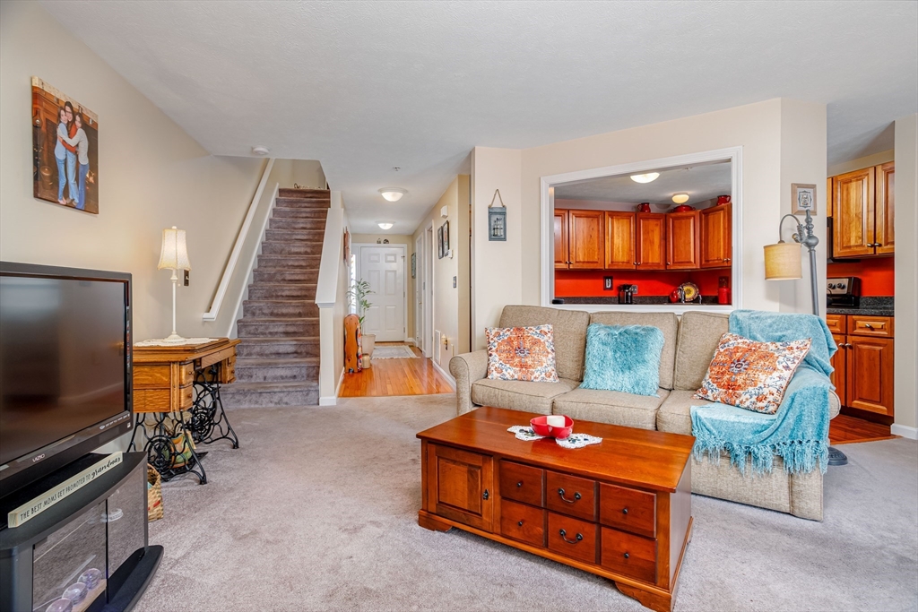 101 Bridle Cross Road, Unit 101 Fitchburg, MA 01420 - Photo 4 of 26 a room with furniture and staircase