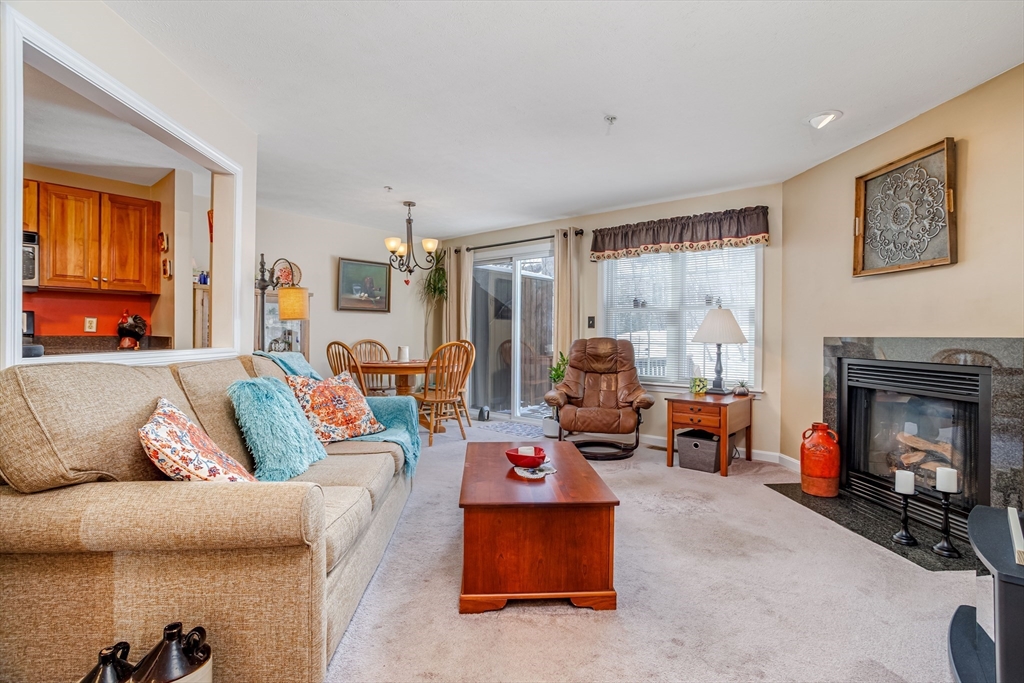 101 Bridle Cross Road, Unit 101 Fitchburg, MA 01420 - Photo 5 of 26 a living room with furniture and a fireplace