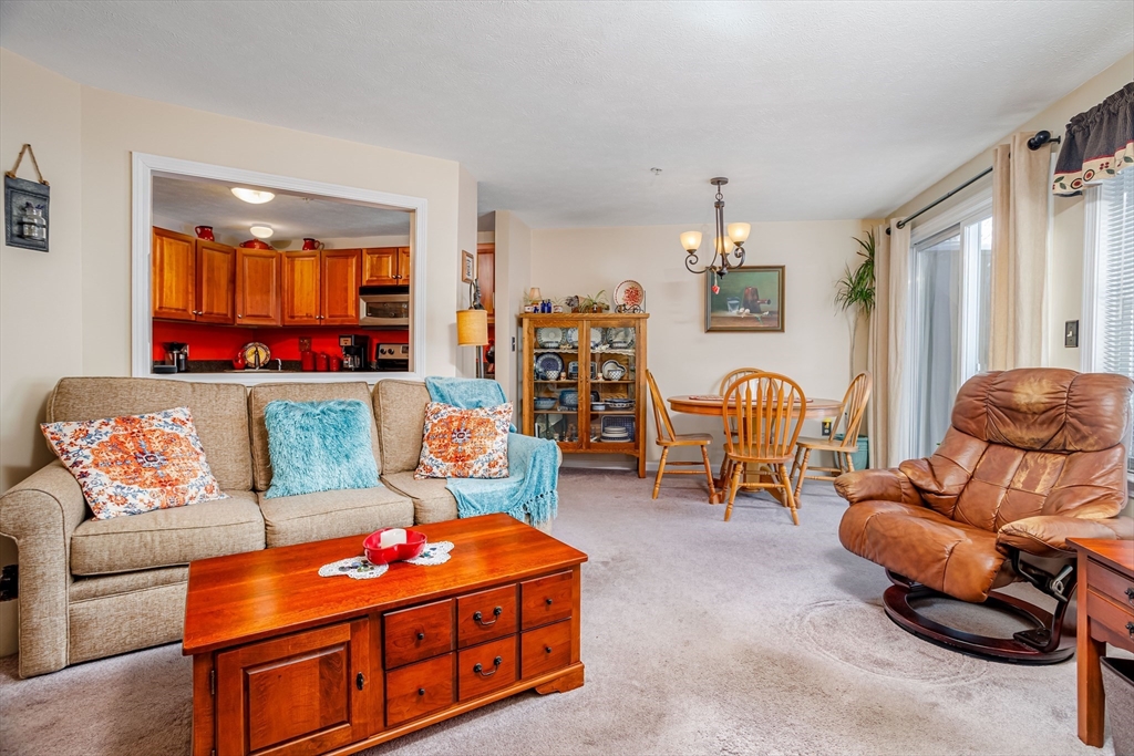 101 Bridle Cross Road, Unit 101 Fitchburg, MA 01420 - Photo 6 of 26 a living room with furniture and a flat screen tv
