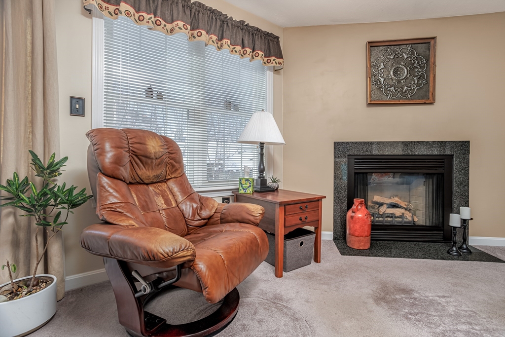 101 Bridle Cross Road, Unit 101 Fitchburg, MA 01420 - Photo 8 of 26 a living room with furniture and a fireplace