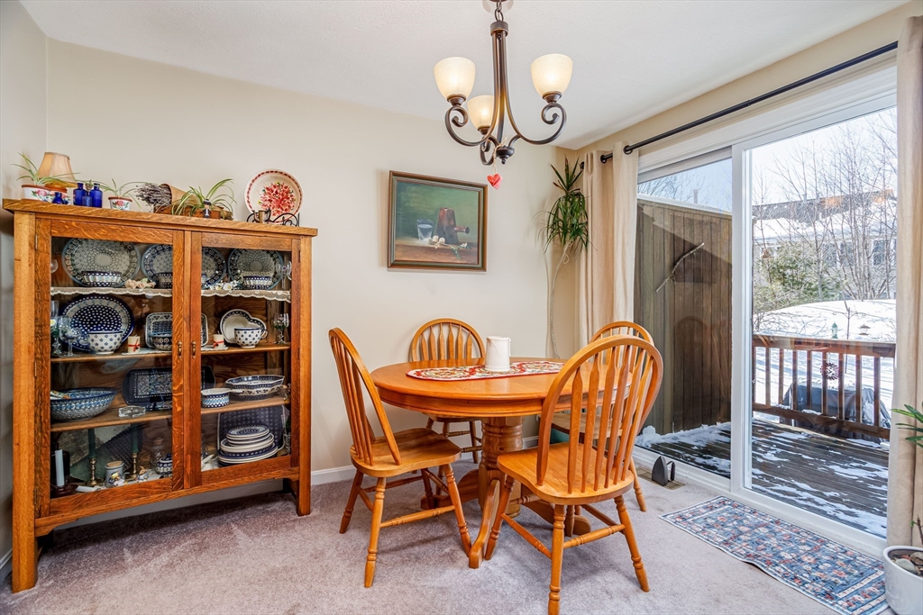 101 Bridle Cross Road, Unit 101 Fitchburg, MA 01420 - Photo 10 of 26 a view of a dining room with furniture window and wooden floor