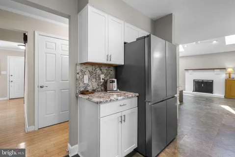 a kitchen with stainless steel appliances granite countertop a refrigerator and a stove top oven