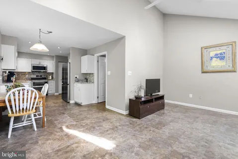 a kitchen with granite countertop a refrigerator and a stove top oven