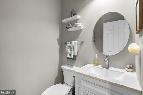 a bathroom with a sink mirror and toilet