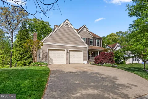 a front view of a house with a garden and yard