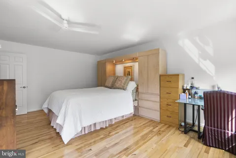 a bedroom with a bed and cabinets