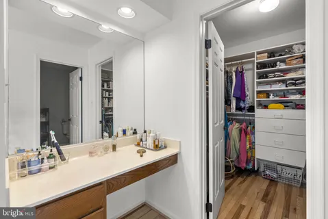 a bathroom with a sink vanity and a mirror