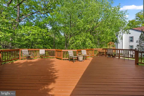 a view of a backyard with table and chairs under an umbrella