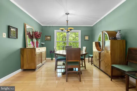 a dining room with furniture a chandelier and window