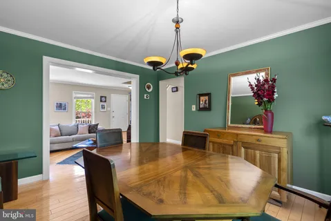 a living room with dining table and chairs
