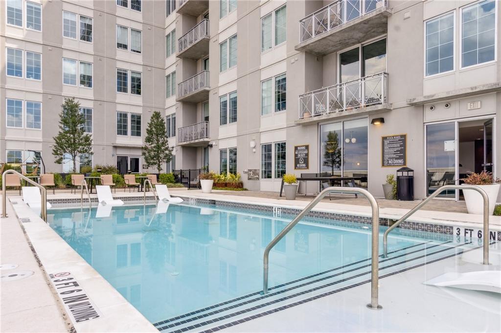 22 Airline Street Southeast, Unit 204 Atlanta, GA 30312 - Photo 32 of 34 a view of a swimming pool with a lounge chairs