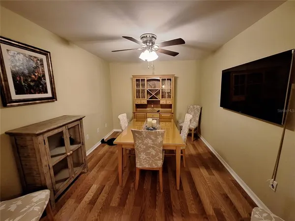 a view of a livingroom with furniture and a ceiling fan