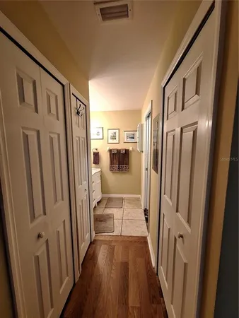 a view of a hallway with wooden floor and staircase