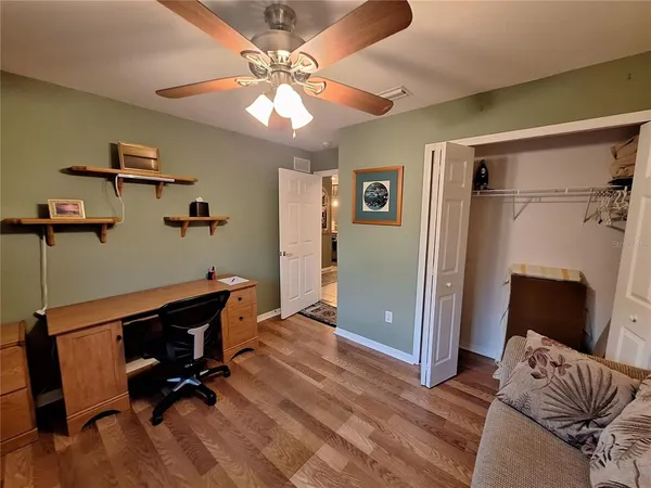a view of workspace with wooden floor windows
