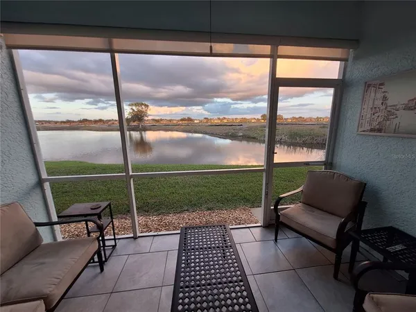 a living room with a floor to ceiling window and a table