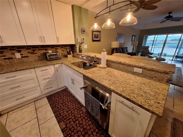 a kitchen with a sink a stove and cabinets