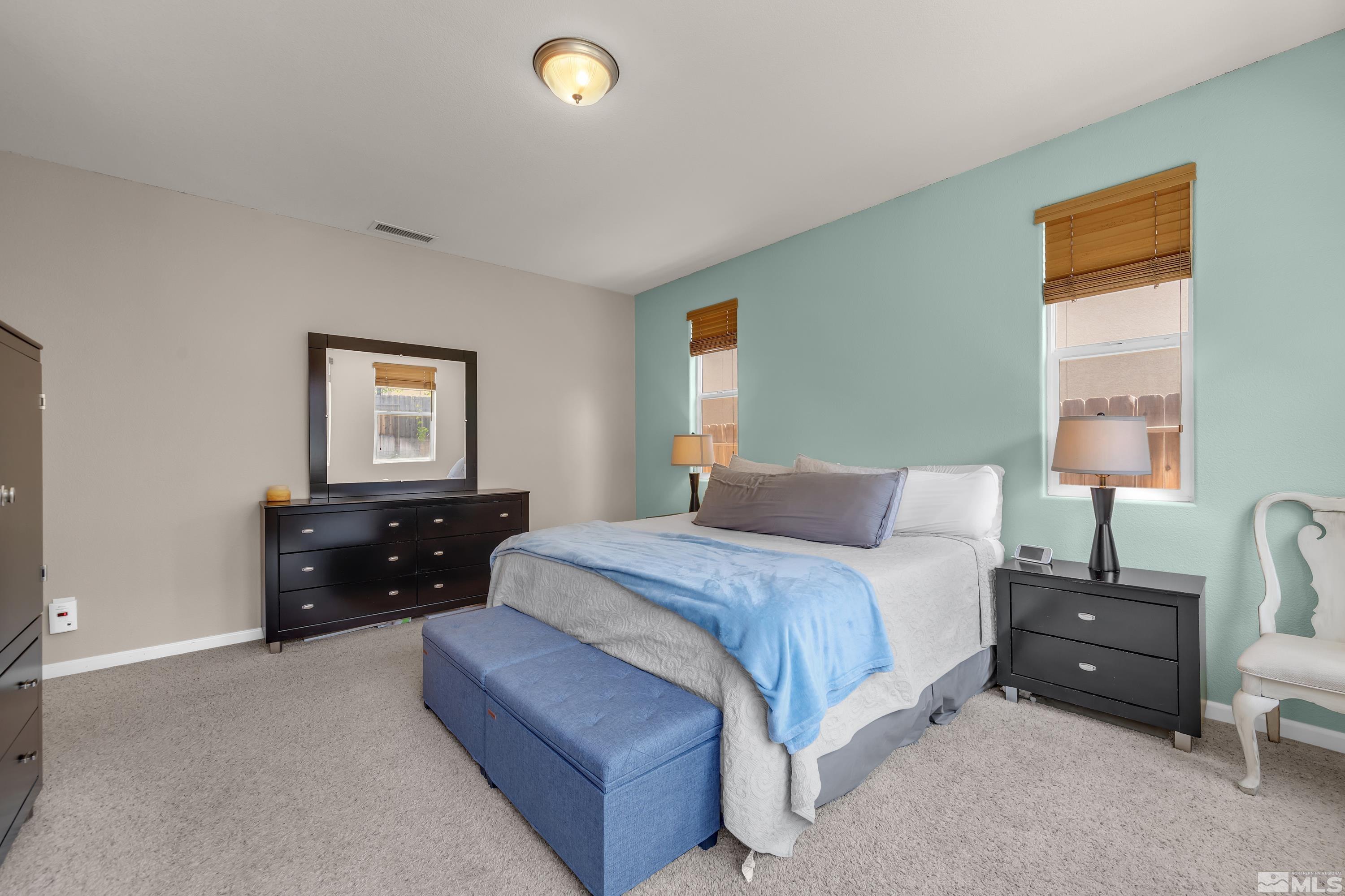 2100 Angel Ridge Drive Reno, NV 89521 - Photo 15 of 35 a bedroom with a bed and a lamp on dresser