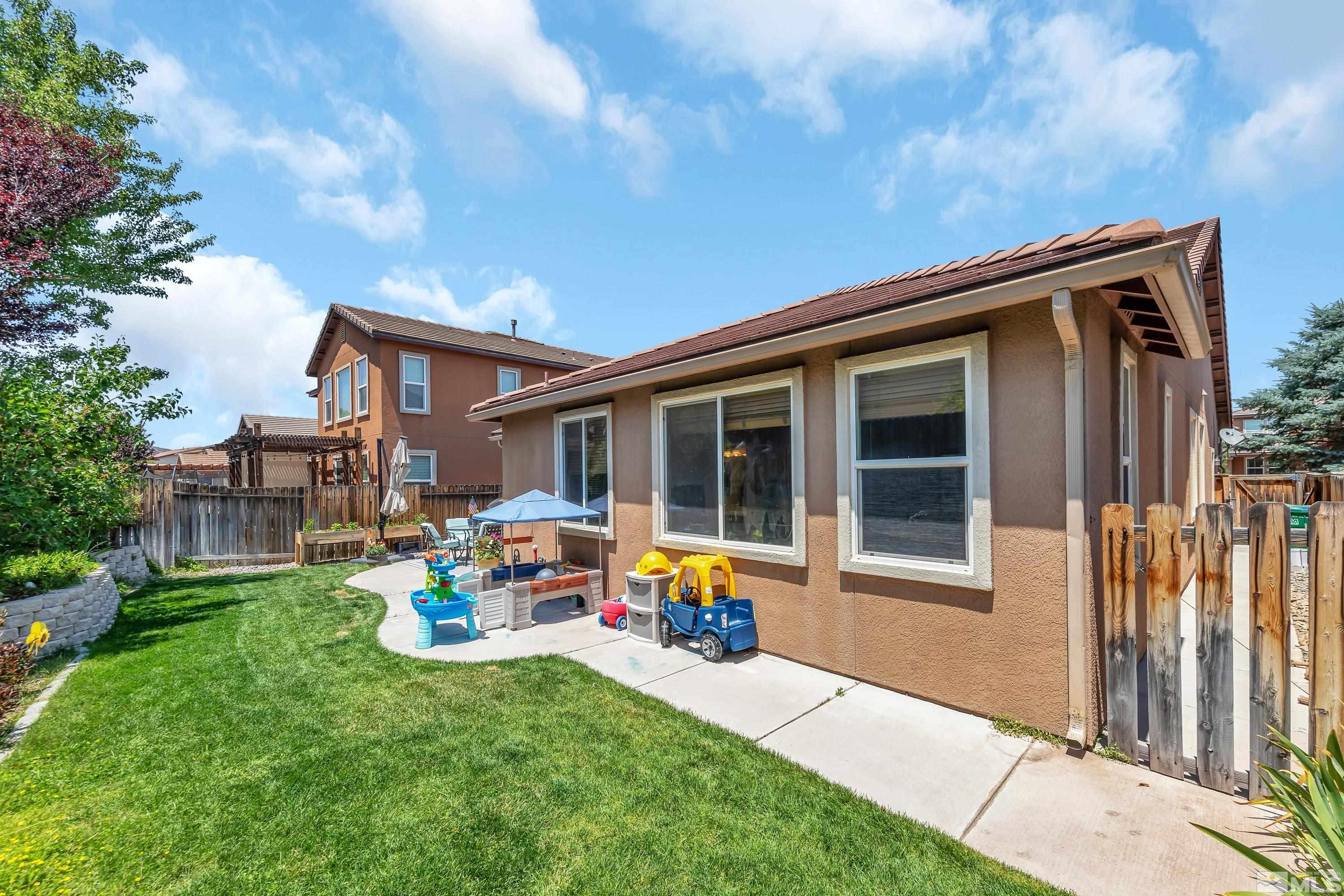 2100 Angel Ridge Drive Reno, NV 89521 - Photo 5 of 35 a backyard of a house with a garden and barbeque oven