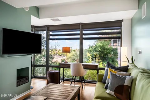 a living room with furniture a flat screen tv and a fireplace