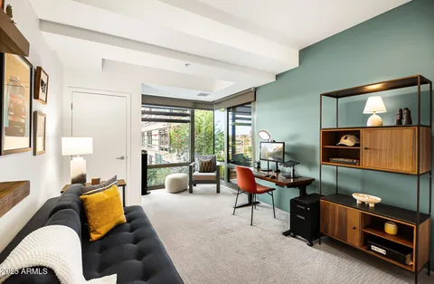 a bedroom with furniture and a large window