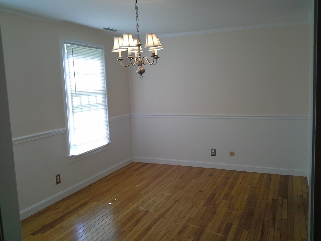 123 Jericho Road, Unit 123 Weston, MA 02493 - Photo 2 of 12 wooden floor in an empty room with a window