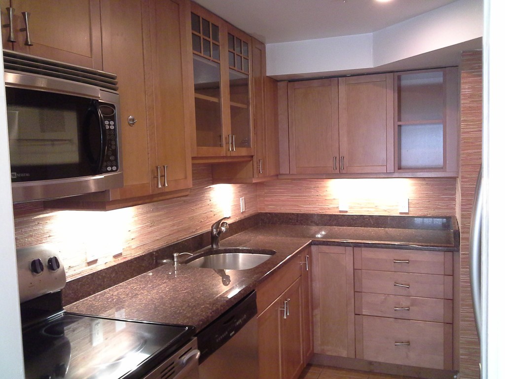 123 Jericho Road, Unit 123 Weston, MA 02493 - Photo 3 of 12 a kitchen with granite countertop a sink stainless steel appliances and cabinets