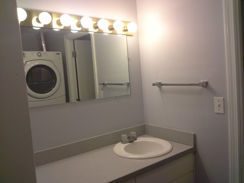 123 Jericho Road, Unit 123 Weston, MA 02493 - Photo 10 of 12 a bathroom with a sink and a mirror