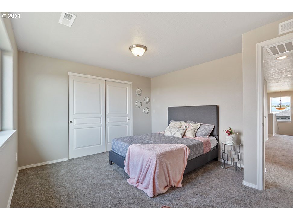 5252 Squirrel Street Springfield, OR 97478 - Photo 15 of 15 a bedroom with a bed and a night stand