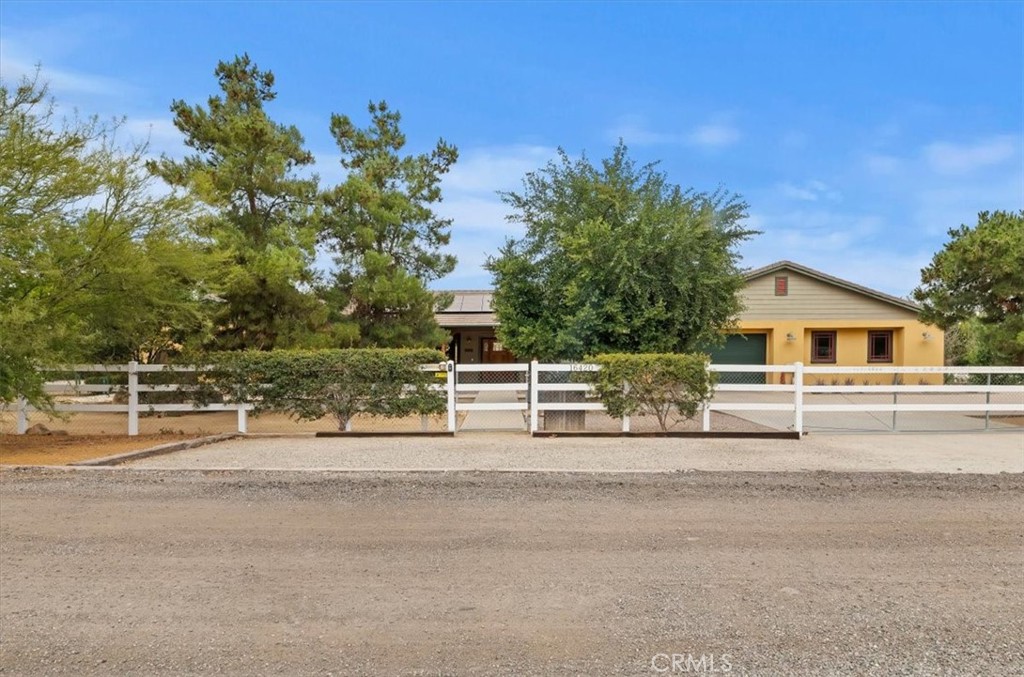 16420 Rocky Glen Road Perris, CA 92570 - Photo 9 of 74 a front view of a house with a yard