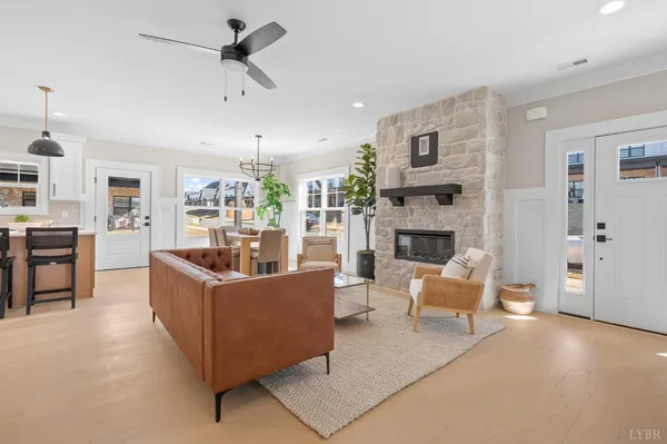 a dining room with furniture potted plants and wooden floor