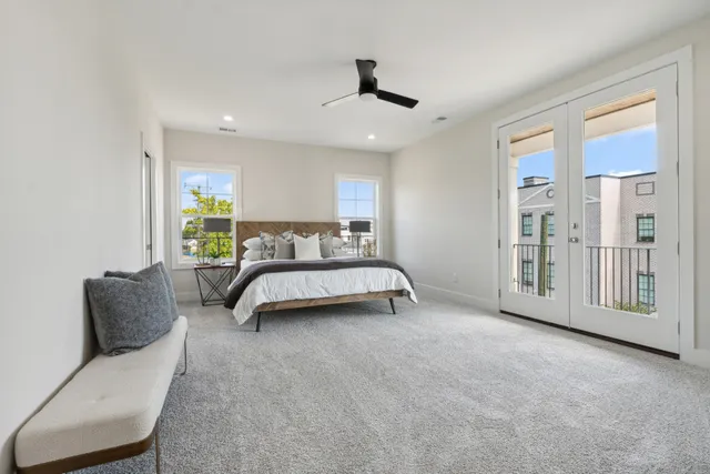 a bedroom with a bed couch and a window