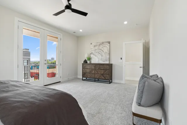 a spacious bedroom with a bed and ceiling fan