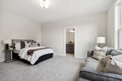 a bedroom with a bed and lamp