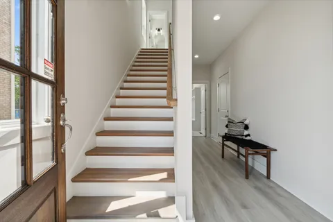 a view of entryway and hall with wooden floor