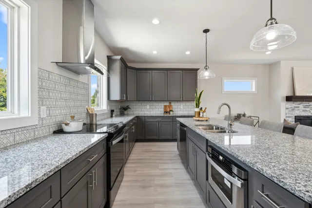 a large kitchen with stainless steel appliances granite countertop plenty wooden cabinets