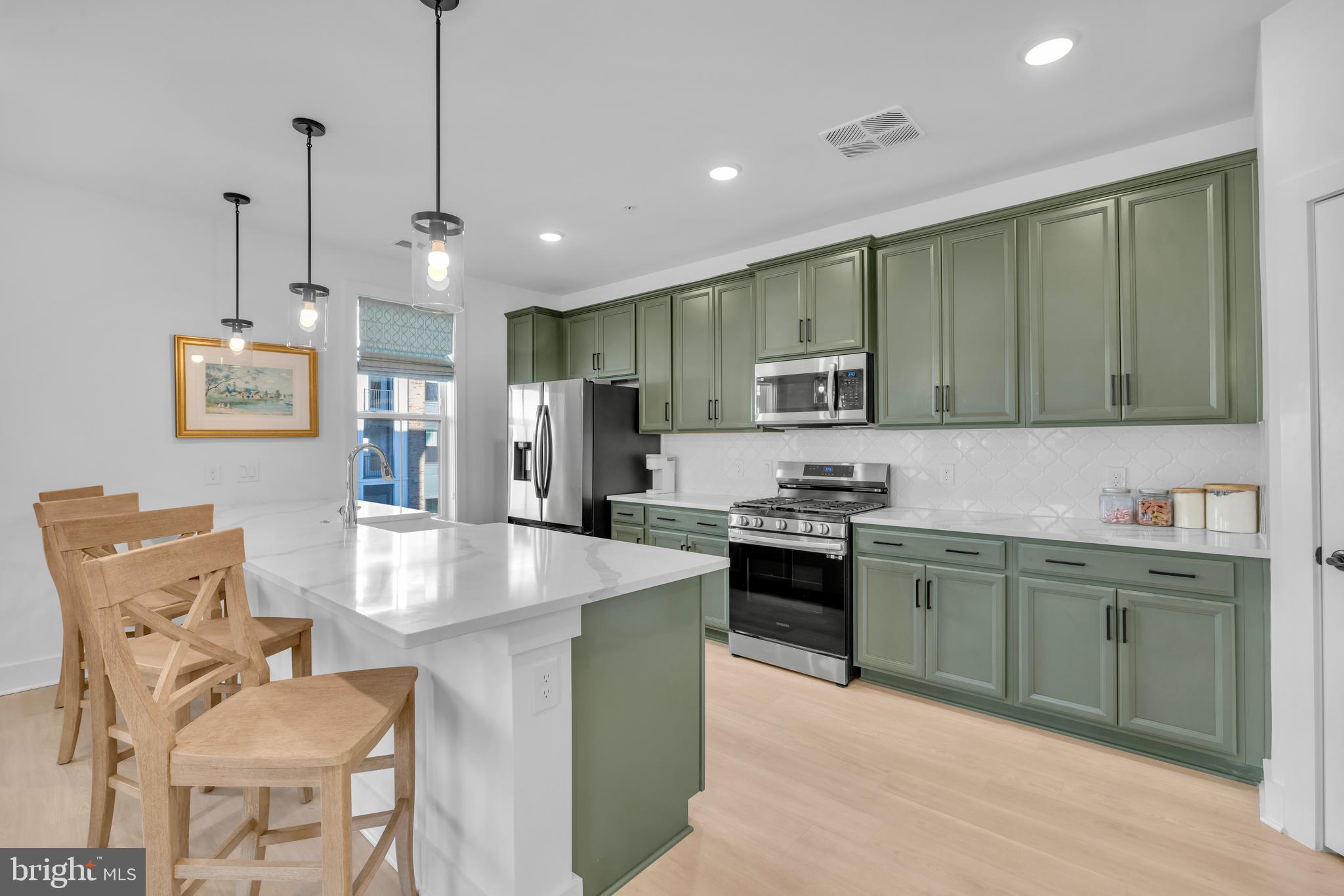 78 Old Mill Bottom Road North, Unit 101 Annapolis, MD 21409 - Photo 5 of 29 a kitchen with stainless steel appliances granite countertop a stove top oven a sink a refrigerator and chairs