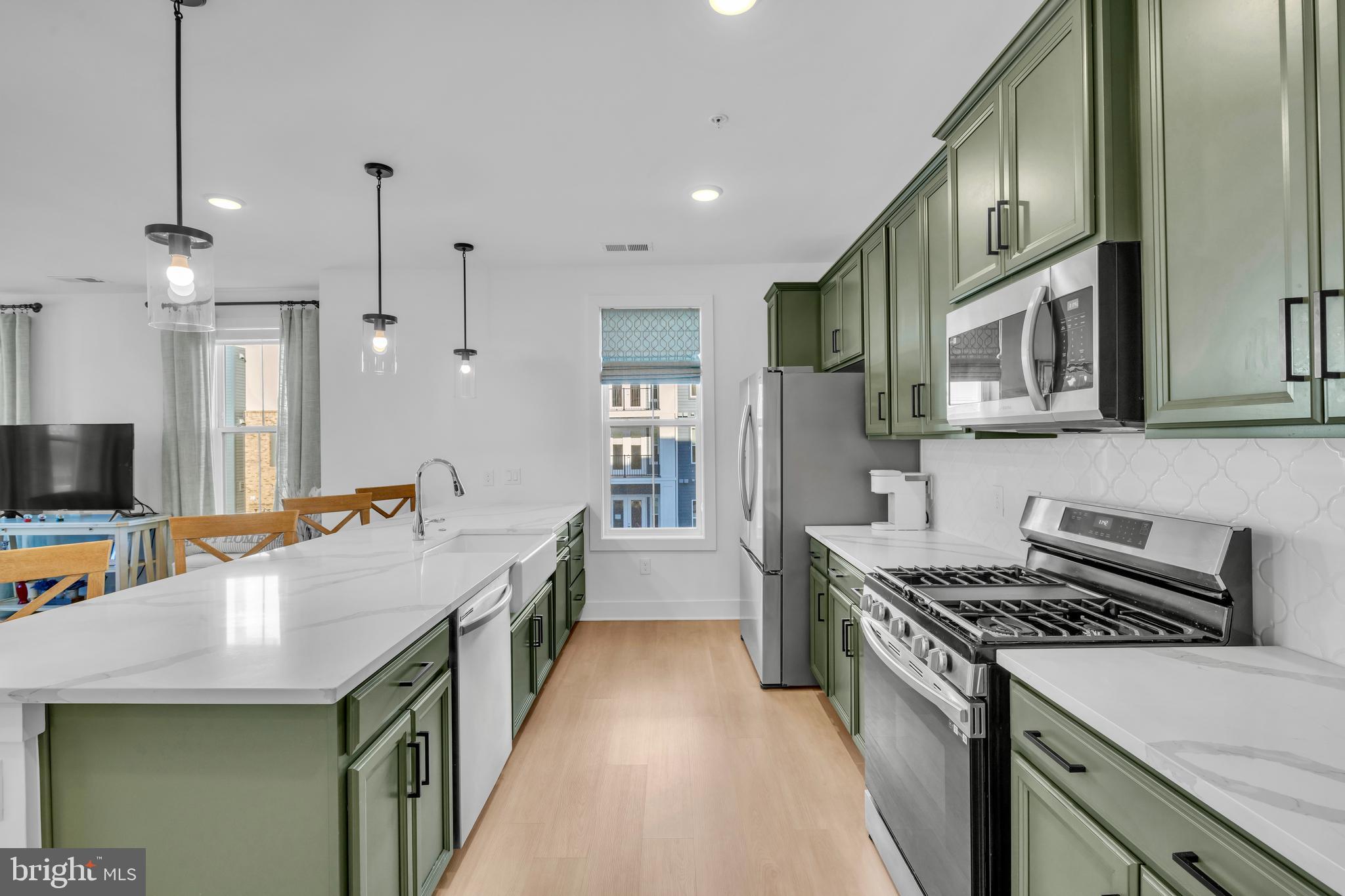 78 Old Mill Bottom Road North, Unit 101 Annapolis, MD 21409 - Photo 6 of 29 a kitchen with stainless steel appliances granite countertop a stove and a sink