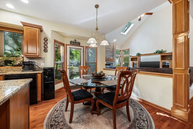 a dining room with furniture a chandelier and window