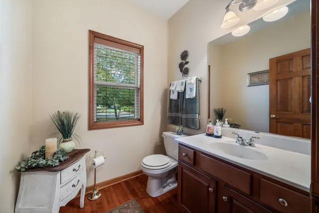 a bathroom with a granite countertop sink toilet a large mirror and shower