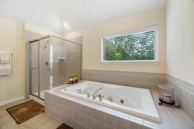 a bathroom with a tub and a shower
