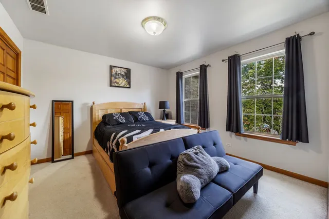 a bedroom with bed couch and window