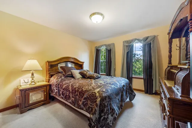 a bedroom with a bed next to a window with tv