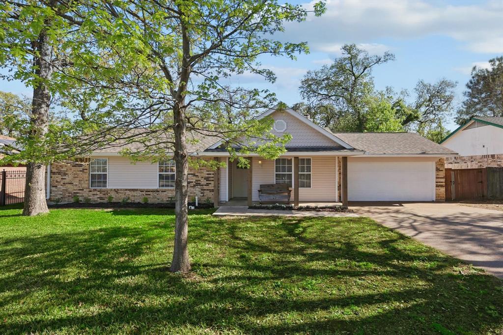 a house that has a big yard with large trees