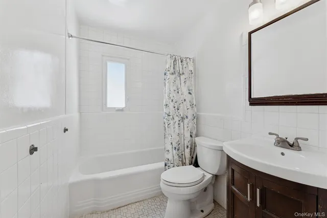 a bathroom with a sink toilet a mirror and shower