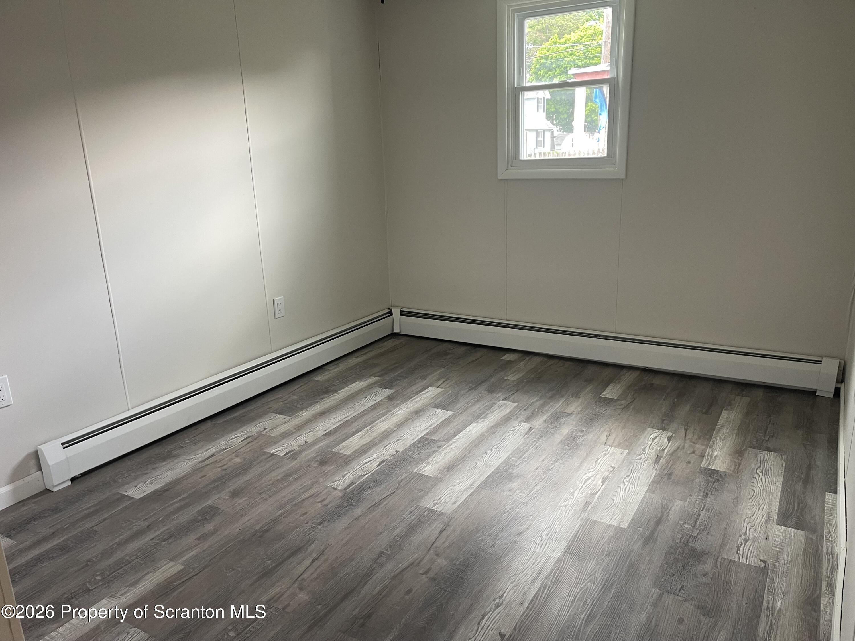 238 George Street Moosic, PA 18507 - Photo 14 of 23 an empty room with wooden floor and windows
