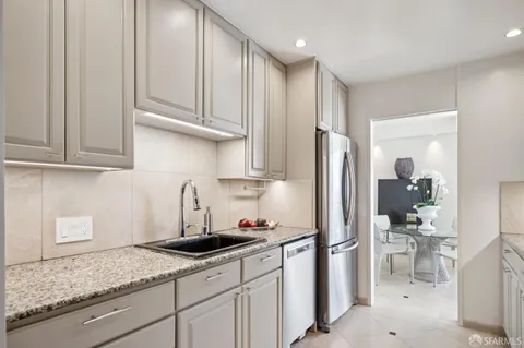 a kitchen with stainless steel appliances granite countertop a refrigerator sink and cabinets