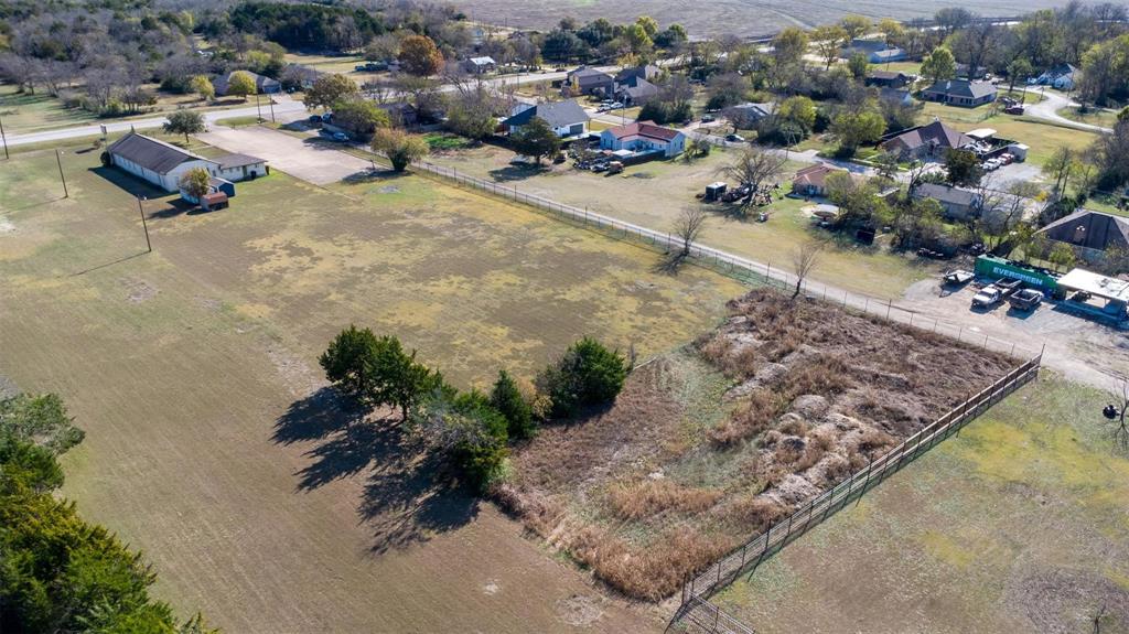 20 South Lancaster Hutchins Road Lancaster, TX 75146 - Photo 13 of 14 Expansive undeveloped land parcel featuring a perimeter fence and mature trees