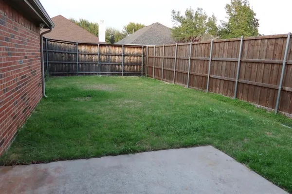 a view of a backyard with a fence
