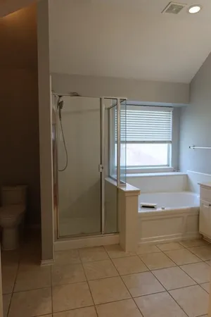 a bathroom with a bathtub and a shower